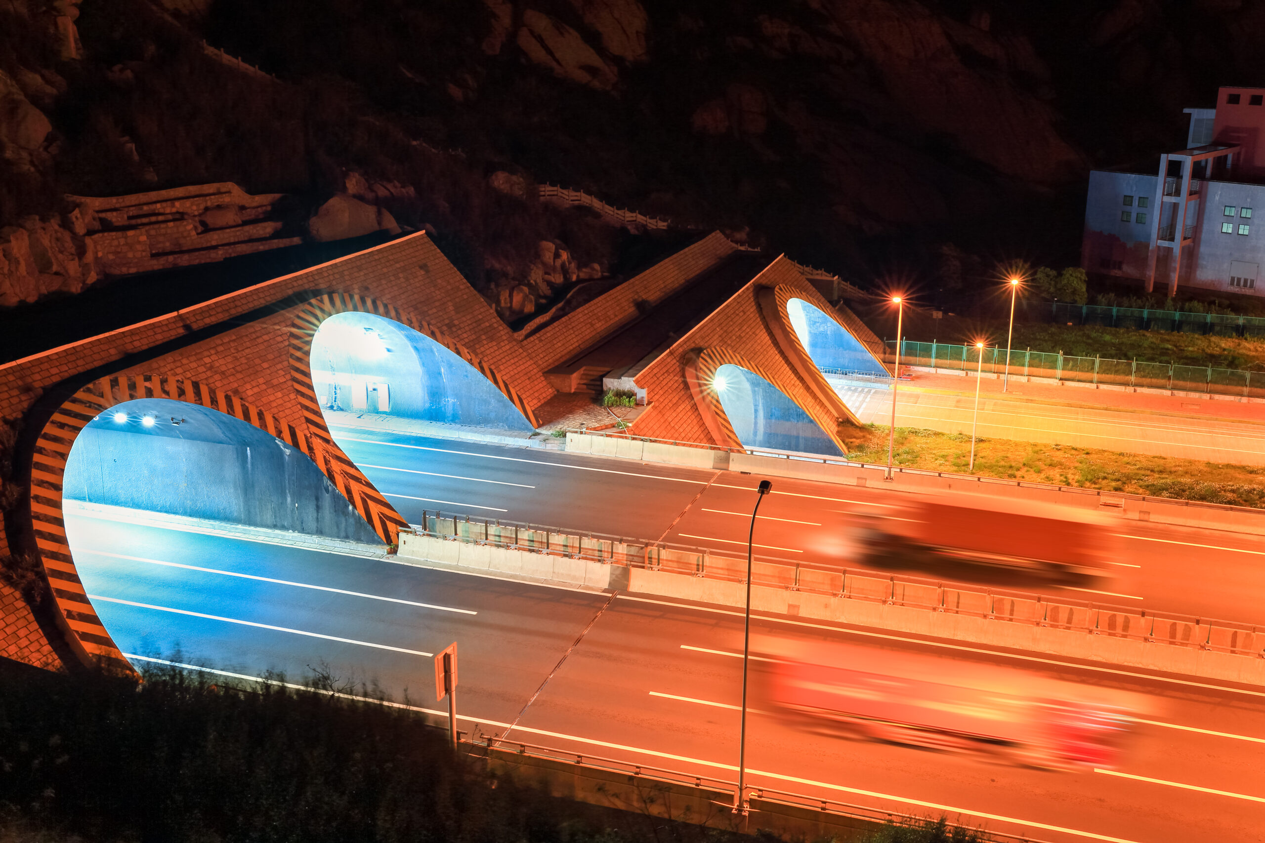 highway tunnel at night and container truck motion blur